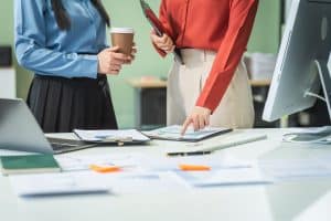 Two Asian Business Woman at a Desk