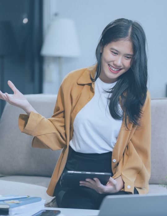 Pict 4 A woman gesturing expressively while holding a tablet, smiling during a discussion, emphasizing effective communication skills.