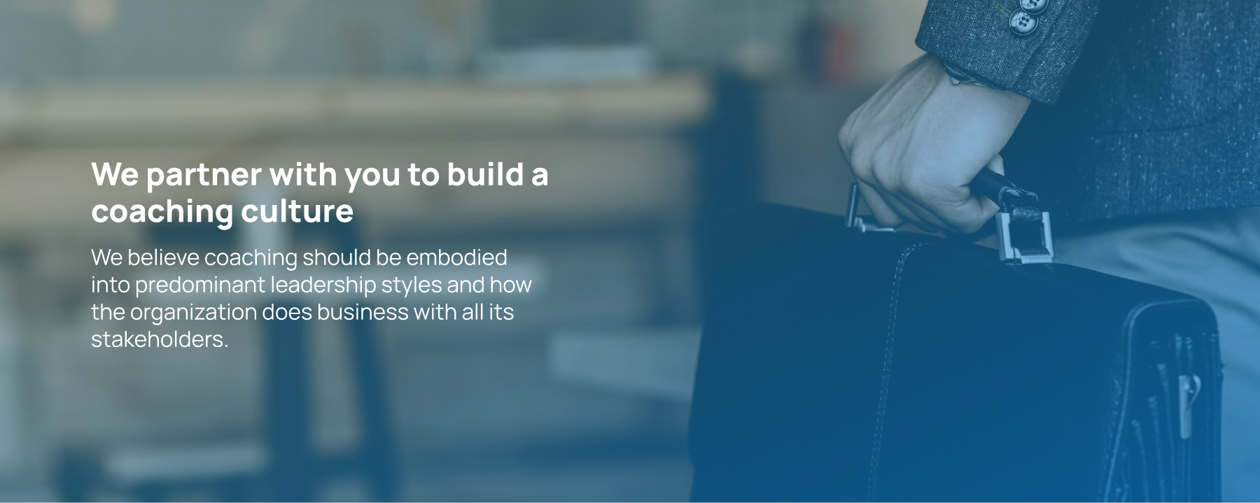 Homepage banner 1 A person with a briefcase and text about building a coaching culture, emphasizing leadership and collaboration in coaching Indonesia.