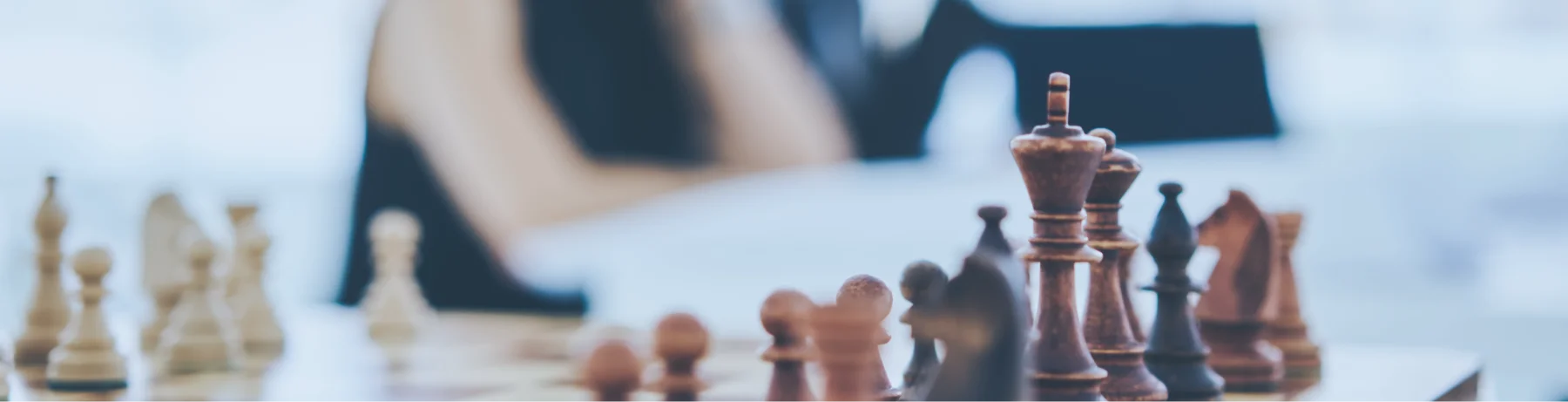 Strategic execution coaching session illustrated by a chessboard strategy with team members planning in the background.